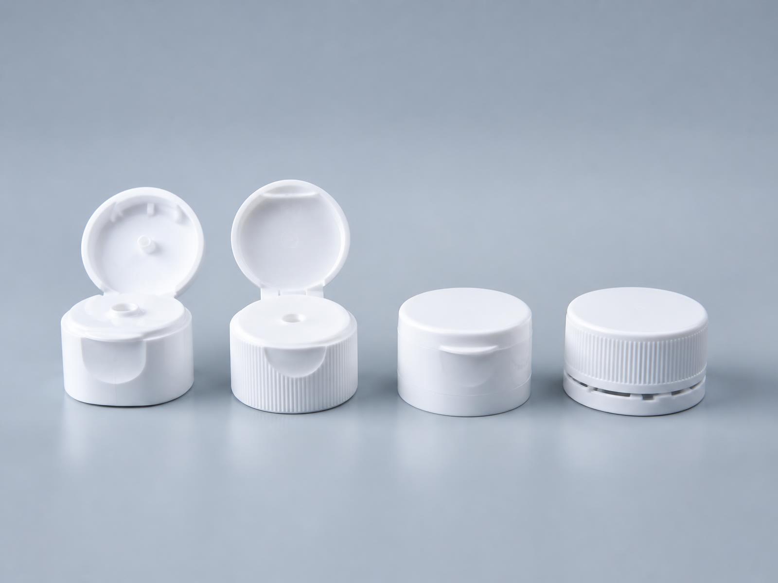 Composition of white and navy plastic closures and caps