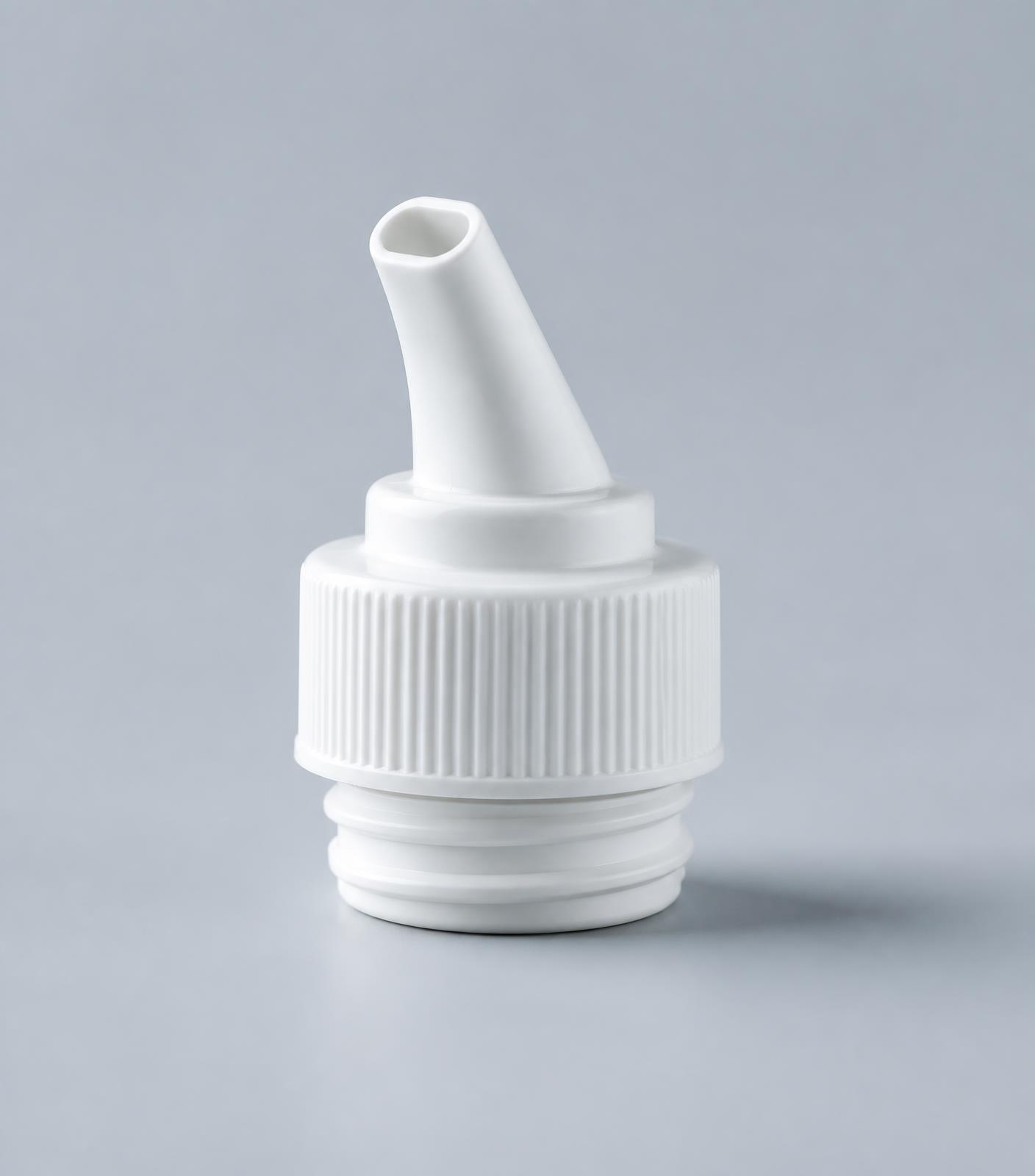 White plastic spout cap dispensing closure photographed in studio light